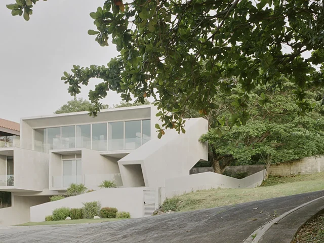 Exterior of CAZA’s FR House, Punta de Fuego—window openings and interlocking volumes set against a natural landscape.