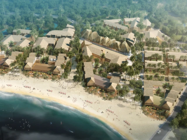 Aerial view of Lio Masterplan beachfront resort with clustered thatched-roof buildings surrounded by palm trees.