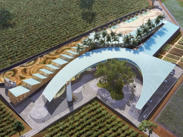 Aerial view of Memphis Mission Hospital with curved roofline, modular pavilions, and surrounding farmland.