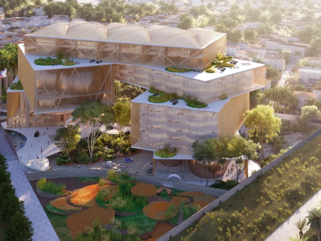 Aerial view of the New Supreme Court building with stacked, gold-toned volumes, rooftop gardens, and landscaped public plaza.